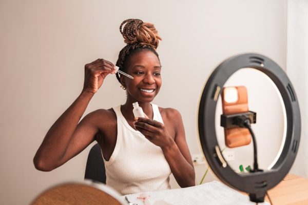 African American Beauty Blogger Demonstrating How to Apply Facial Serum