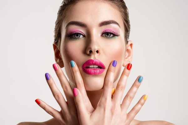 Beautiful fashion woman with a colored nails.