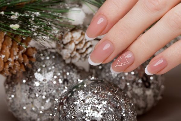Snow White manicure on female hands. Winter nail design.