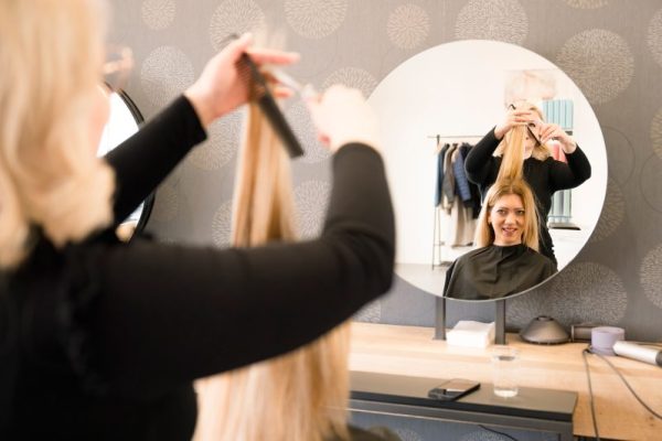 Woman get a hair cut from hair stylist, hair dresser