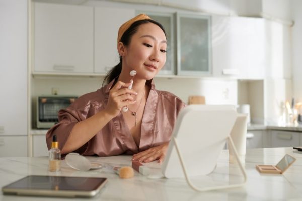 Woman Massaging Face with Quartz Roller