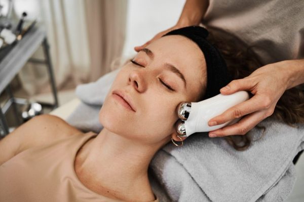 Women's face massage with gadgets.